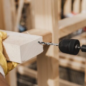 close-up-person-holding-hammer-drill