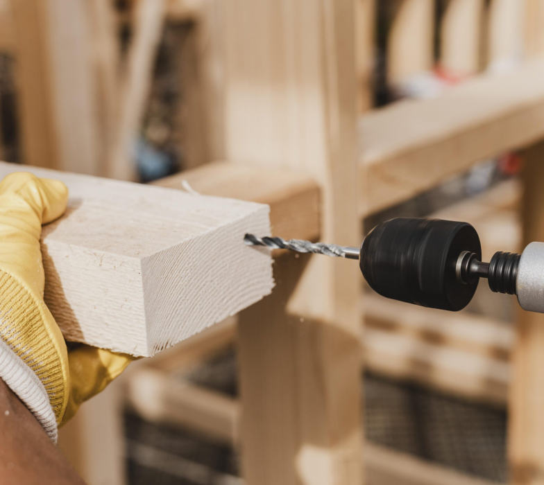 close-up-person-holding-hammer-drill